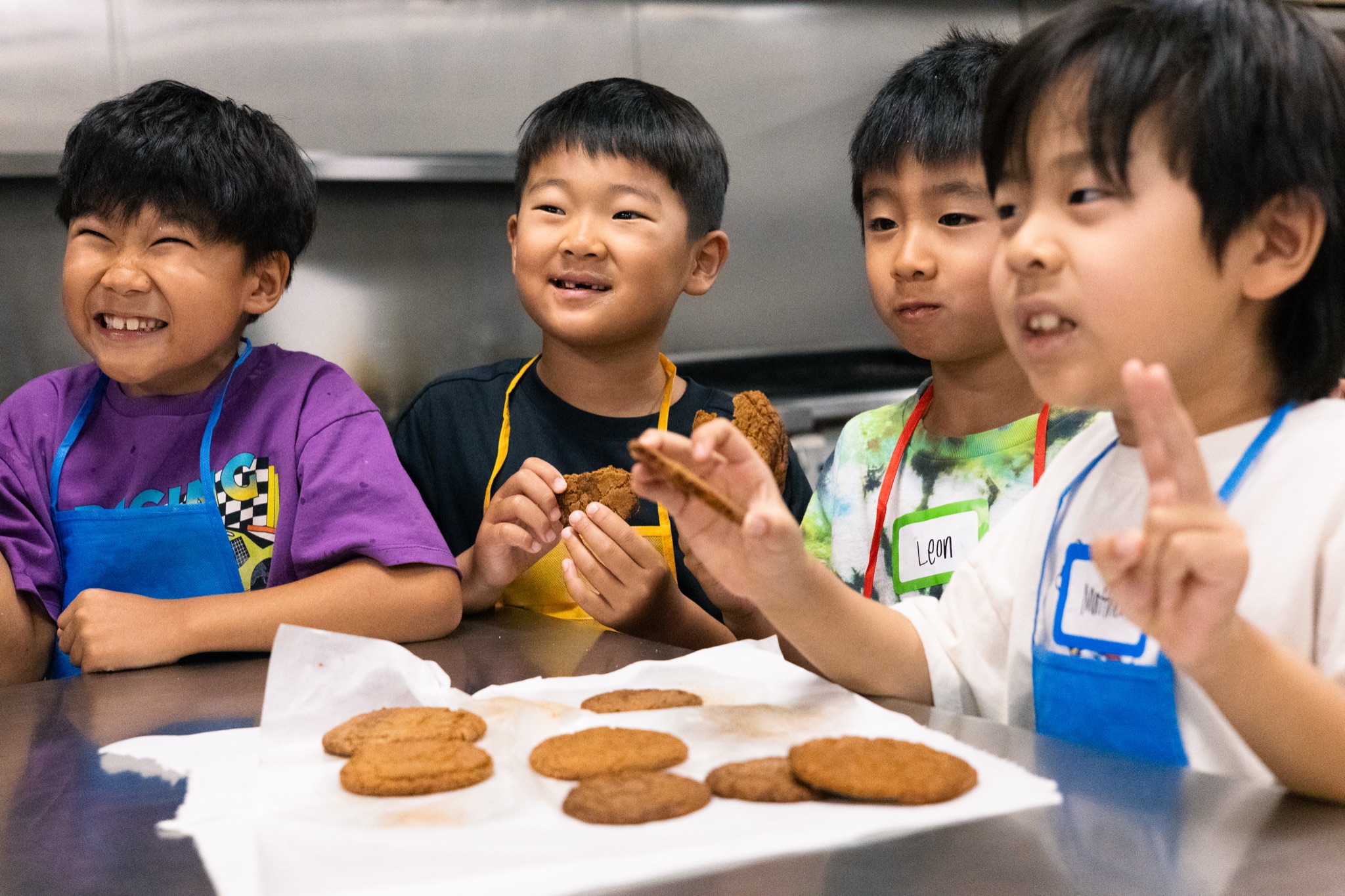 Students smiling with freshly baked cookies